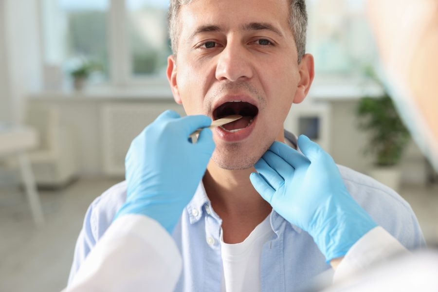 Dentist Examining Patient’s Mouth for Oral Irritation and Lesion – Painful Sore on Tongue